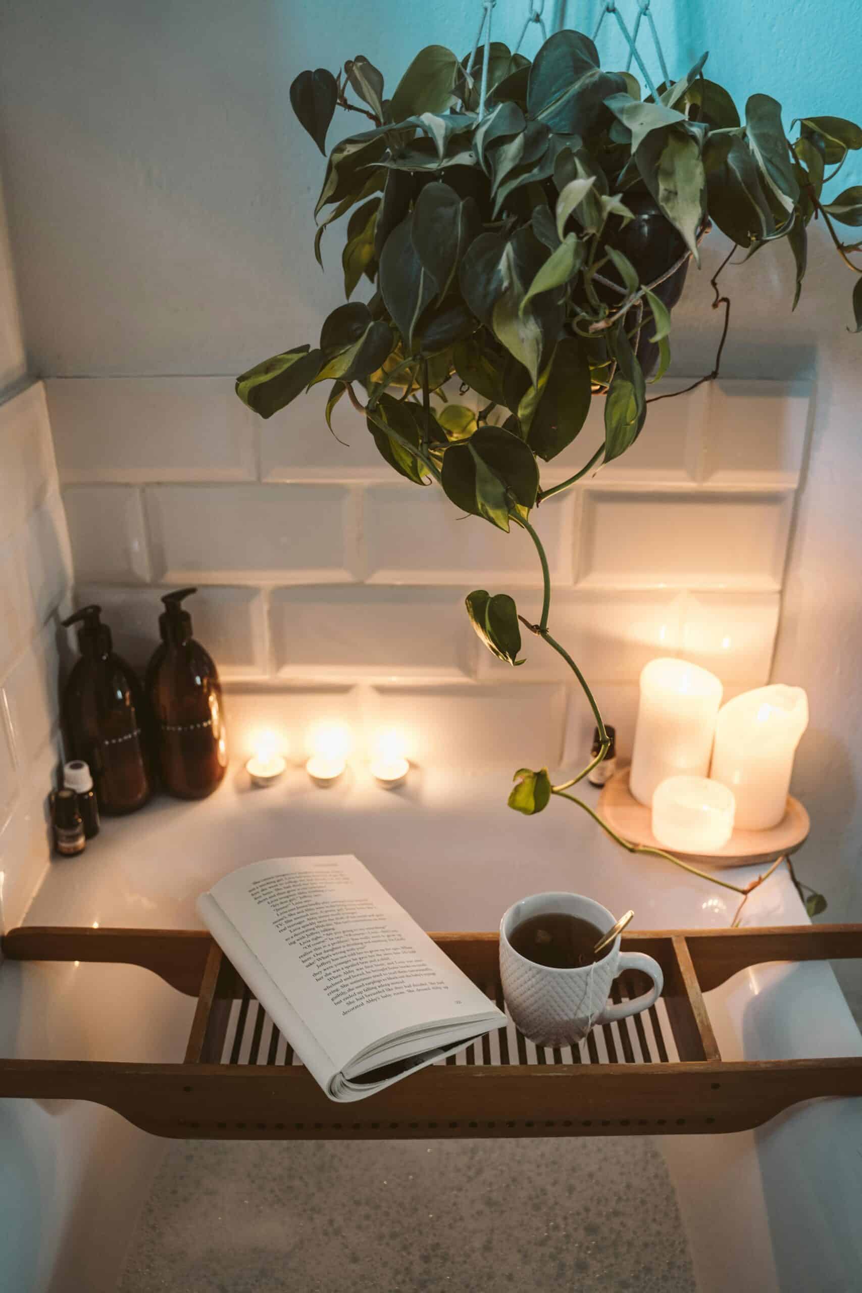 Relaxing bath setup with candles, tea, and a book after a MaiditUp house cleaning service in Queen Creek, Mesa, Chandler, Gilbert, Scottsdale, or Tempe